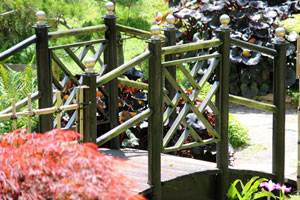 Photo of a timber bridge, made from posts and finials painted gold